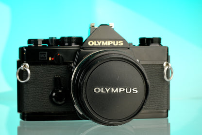 Olympus OM-1 35mm SLR Film Camera (Black) + 50mm f/1.4 Black Nose Lens