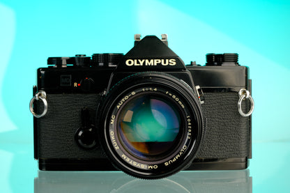 Olympus OM-1 35mm SLR Film Camera (Black) + 50mm f/1.4 Black Nose Lens