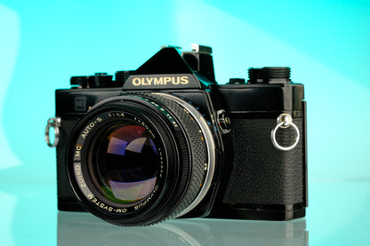 Olympus OM-1 35mm SLR Film Camera (Black) + 50mm f/1.4 Black Nose Lens