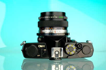 Olympus OM-1 35mm SLR Film Camera (Black) + 50mm f/1.4 Black Nose Lens