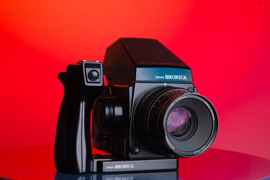 Bronica medium format film camera with speed grip and metered prism finder.